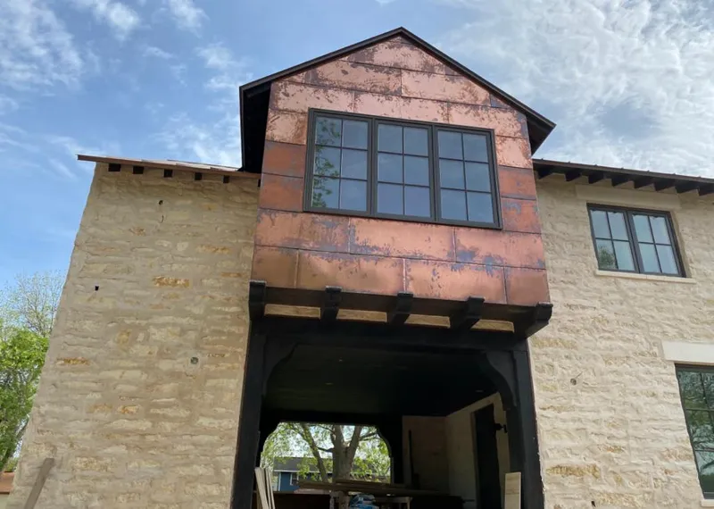 Copper metal panel facade on a stone building for Skylight Installation in Edgemoor